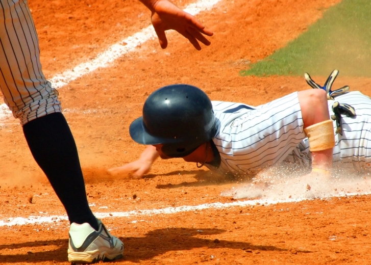 baseball player sliding into base